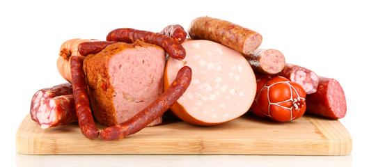Lot of different sausages on wooden board isolated on white