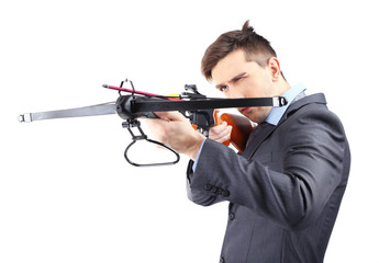 Young businessman with crossbow, isolated on white