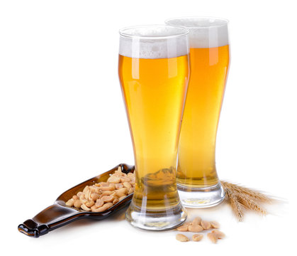 Glasses of beer with snack isolated on white