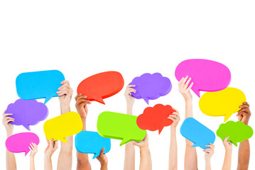 Hands holding multi colored speech bubbles