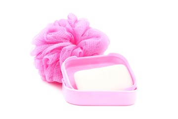 pink soapbox with soap and shower scrubber on white background