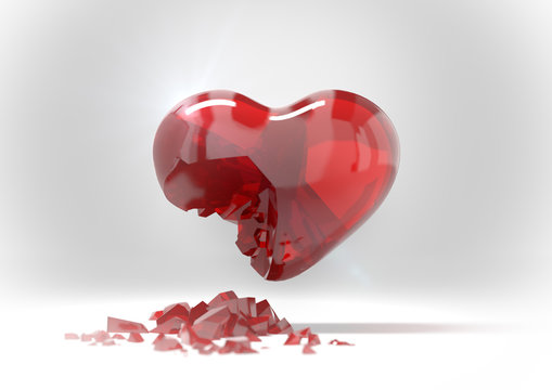 broken a red glass heart and shattered piece on floor