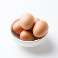 Eggs in white bowl on the white background