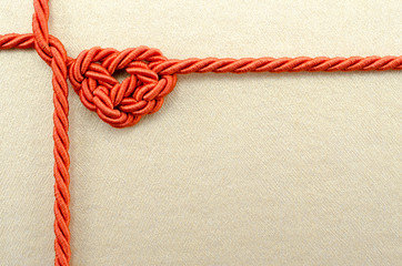 Heart shaped rope on golden texture background