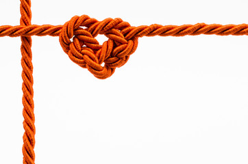 Heart shaped rope on white background