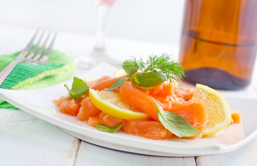fresh salmon with lemon on the white plate