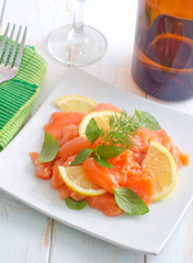 fresh salmon with lemon on the white plate