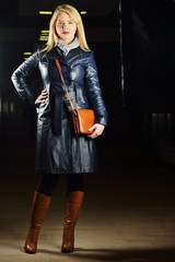 Young beautiful woman posing with fashionable leather clothes
