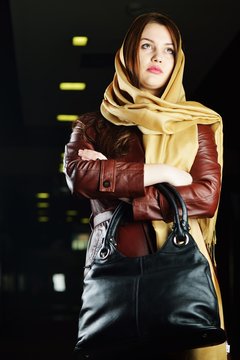 Young beautiful woman posing with fashionable leather clothes