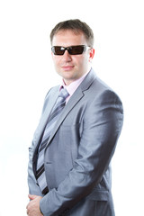Portrait of a handsome young  businessman in glasses in suit