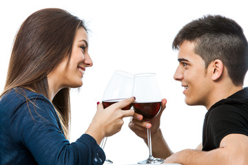 Couple enjoying red wine together.