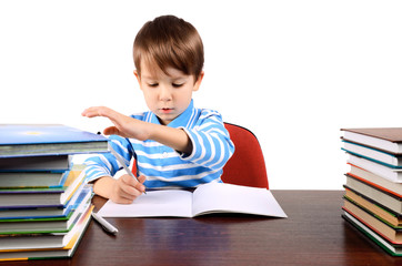 boy writes and takes a book at the same time