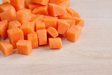 Diced raw carrots on a chopping board