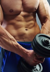 Naklejka premium Body builder champion posing in studio