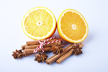 Orange fruit segment, cinnamon sticks and mint isolated on white