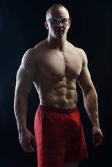 Fototapeta premium Body builder champion posing in studio