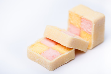 sliced cake, pink, yellow squares in a marzipan coating