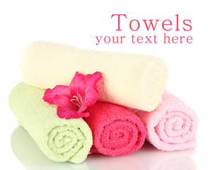 Bright towels and flower isolated on white