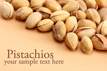 tasty pistachio nuts, on beige background