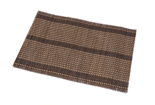 Bamboo brown straw serving mat isolated over white background