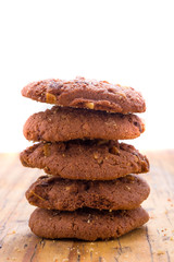 Stack of Chocolate chip cookies on wooden background.