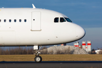 Detail of white plane nose during taxi on taxiway