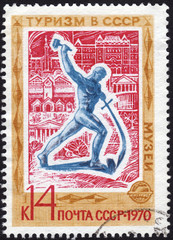 Postage stamp showing a sculpture of a man turning a sword into