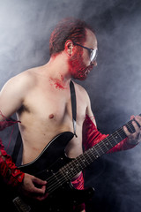 Fototapeta premium guitarist with electric guitar black, wearing face paint and red