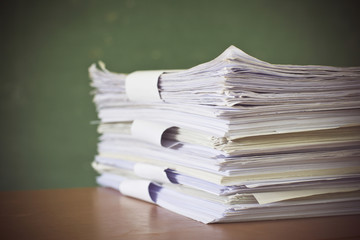 stack of paper on blackboard