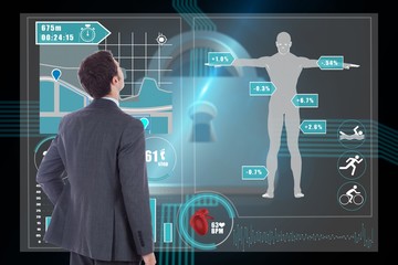Composite image of businessman standing with hand on hip