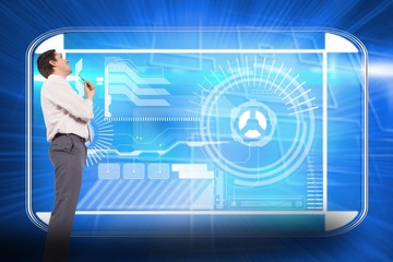 Composite image of thinking businessman holding pen