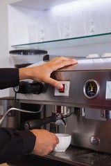Barista making cup of hot coffee