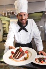 Happy chef offering chocolate cake to camera
