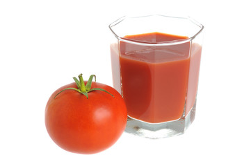 A tomato and a glass filled with tomato juice isolated on white