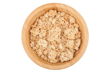 Flakes in wooden bowl isolated on white background