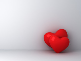 Two red hearts on empty white wall background