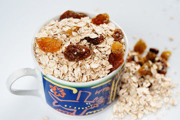 Oatmeal with raisins isolated on a light background