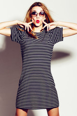 Portrait of beautiful girl in glasses with red lips