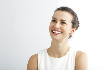 Young woman smiling against white background