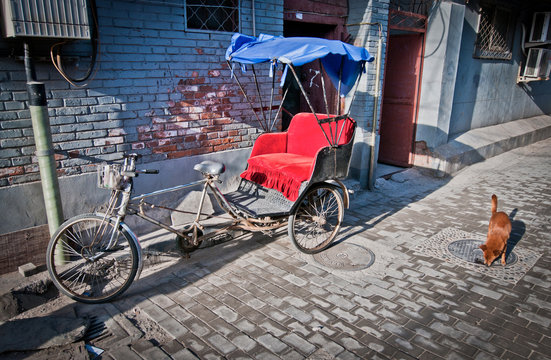 cycle rickshaw on narrow alley in hutong area in Beijing, China