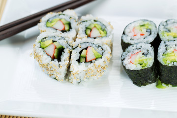Top view shot of California Rolls in white plate
