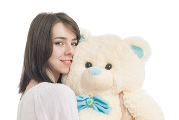 Young girl holding big teddy bear