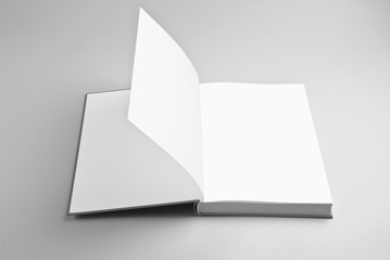 Blank open book over gray background