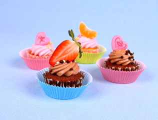 Appetizing cupcakes with angel, heart, tangerine, strawberry
