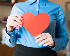 woman holds a heart in his hands