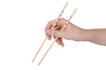 Female hand holding crossed chopsticks with chinese inscription