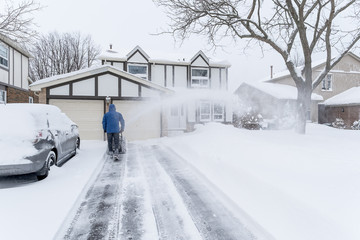 Man Clearing Snow with a Snow Blower