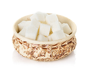 Sugar cubes in a bowl isolated on white background