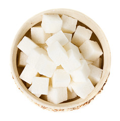 Sugar cubes in a bowl isolated on white background