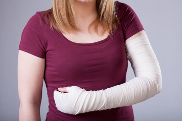 Woman with bandaged arm